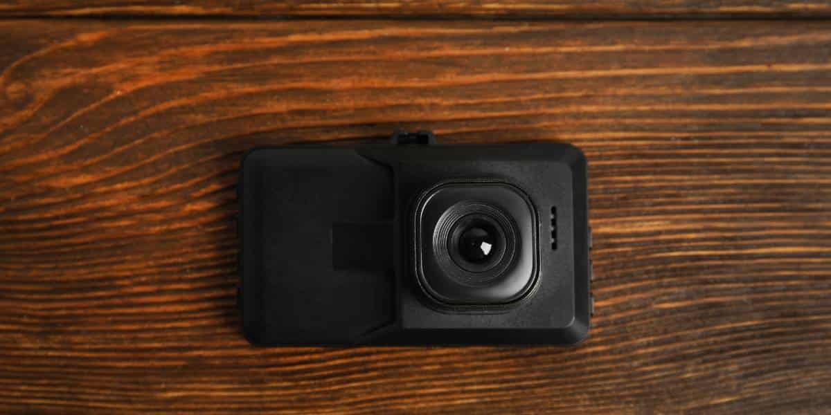 A dash cam that is off on a table.