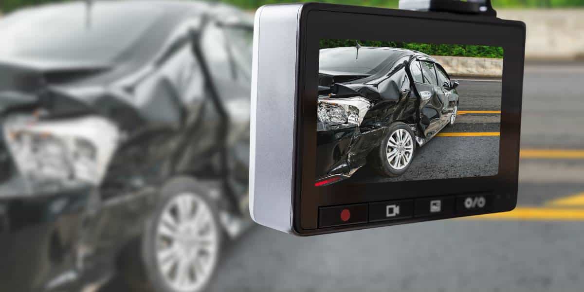 A dash cam displays footage of a damaged car after an accident, highlighting the importance of recording incidents. This image answers the question, why have a dash cam?