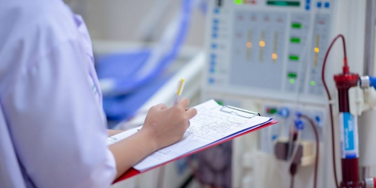 A healthcare professional in a hospital setting reviewing patient records on a clipboard next to medical equipment, representing documentation in a hospital negligence claim