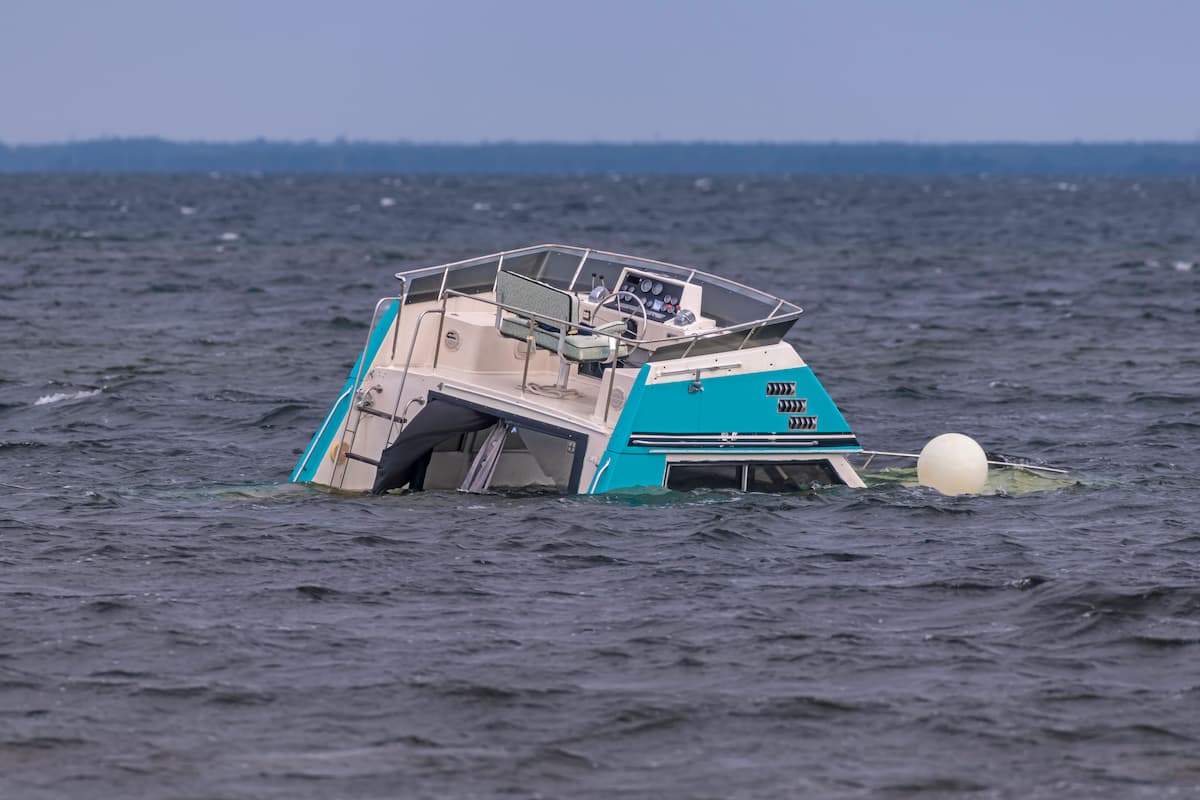 Partially submerged boat in open water, emphasizing the importance of safety and understanding what should you do to avoid colliding with another boat.