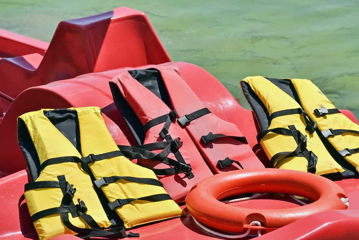 Life jackets and a life ring aboard a boat, essential safety equipment required by Florida law to meet "what must be aboard a vessel in Florida" guidelines."