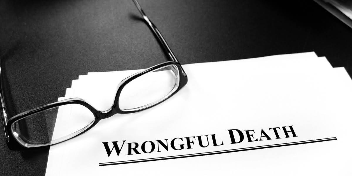 Legal documents with the title "Is Wrongful Death Civil or Criminal" next to black-rimmed glasses, symbolizing legal accountability in wrongful death cases.