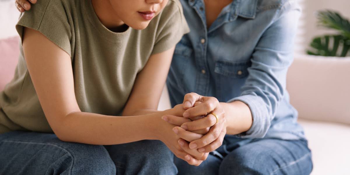 Close-up of two people holding hands in support, symbolizing seeking justice and understanding wrongful death damages.